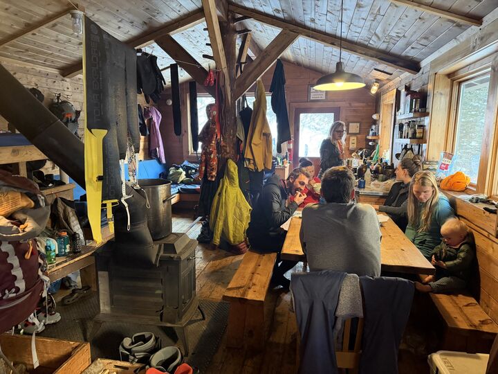 Inside Green-Wilson hut: wood stove and long table